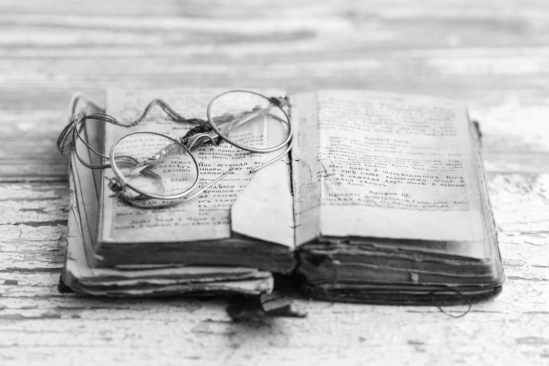 Old spectacles on a book