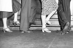 Close-up of people’s shoes at a bar